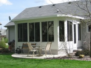 Sunroom addition with white siding on a Wisconsin home