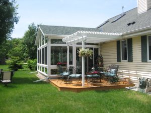 Sunroom attached to home with beige siding