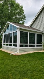 Sunroom with shingle roof and kneewalls that match house's siding