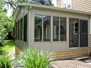 Picture of a beautiful sunroom installed on the back of a house.